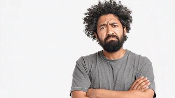 A man with a beard and a beard is standing with his arms crossed photo
