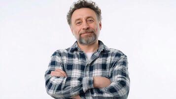 A man with a beard and plaid shirt standing with his arms crossed photo