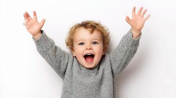 A young child with his hands up in the air photo