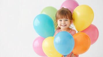 A little girl holding a bunch of colorful balloons photo