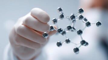 A person holding a molecule model in their hand photo