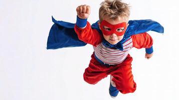 A young boy in a superhero costume flying through the air photo