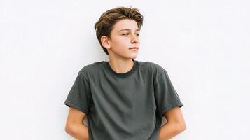 A boy is sitting on a white wall photo