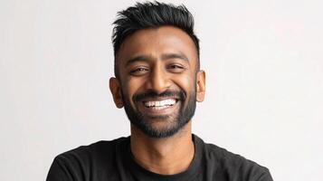 A smiling man with a beard and a black shirt photo