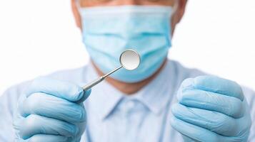 A man in a blue shirt and blue gloves is holding a spoon photo