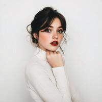 Beautiful young woman with red lips and white sweater photo