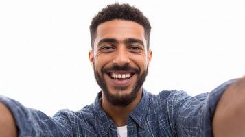 A man is smiling and taking a selfie photo
