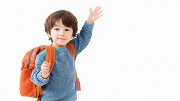 A young boy with a backpack waving photo