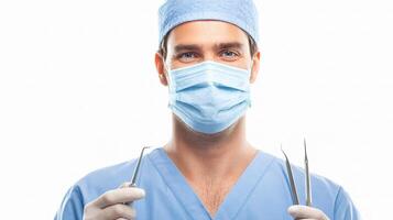 A man in scrub clothes holding surgical tools photo