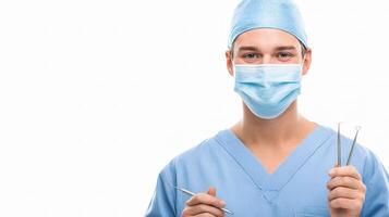 A male surgeon in a blue scrub suit holding a pair of scissors photo
