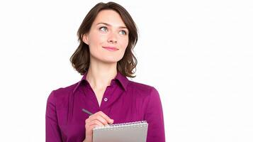 A woman is holding a pen and writing on a notepad photo