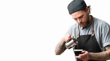 A bearded man in an apron pouring coffee photo