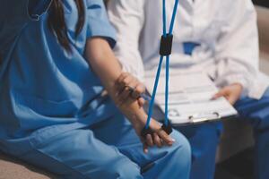 A nurse is holding a stethoscope to a patient's chest photo