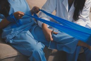 Two women in scrub suits are sitting on a couch photo