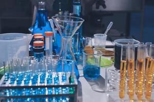A laboratory table with many different colored liquids photo