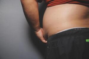 A man with a belly showing off his stomach photo
