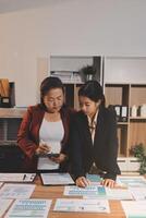 Two businesswomen looking at a tablet computer photo
