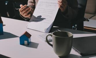 A person is holding a piece of paper with a contract on it photo