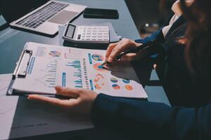 A person is working on a document with graphs and charts photo