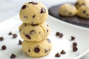 three chocolate chip cookie dough balls on a plate photo