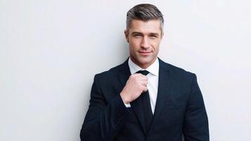 A man in a suit and tie is posing for the camera photo