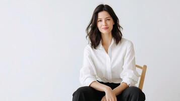 A woman sitting on a chair with her hands crossed photo