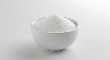 A white cup filled with sugar on a white background photo