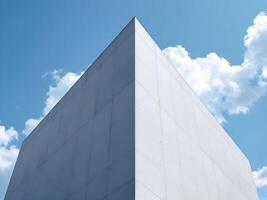 Architectural detail of a modern white building, highlighting sharp angles and deep shadows under a bright sky photo