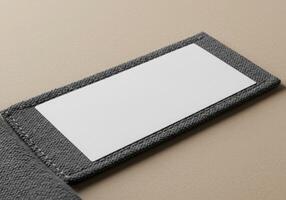 A business card is placed on a gray wallet photo