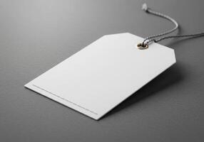 White blank price tag on grey background photo