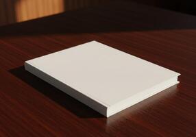 A white book sitting on a table in front of a window photo
