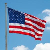 A large american flag flying in the wind photo