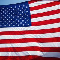 A close up of an american flag with a blue sky photo