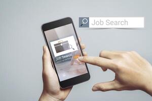 Job Search Career Recruitment Concept. The hand is pressing on the mobile phone screen, touch the click button. at online website photo