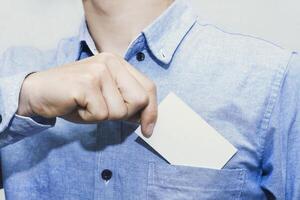 Minimal business card template held by professional man. Great for communication, branding, corporate contact, identity mockup, marketing, business info, message, and visual presentation. photo