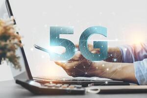 Asian man hand holding a phone with a 5G high speed mobile connection technology signal. Smart city networking concept, high speed mobile internet, new generation network, mixed media and convenience photo