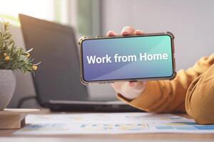 Work from home, Business male casual wear with the message on the smartphone screen Show about working at home during the Corona virus crisis concepts. photo
