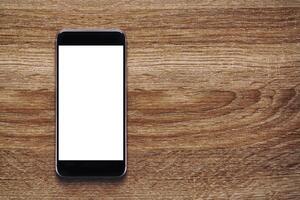 Smartphone with Mockup image white screen On Wooden Table With beautiful patterns, copy space for adding content. Smartphone concept and lifestyle, clipping path photo