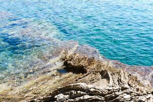 Beautiful seascape with a view of the sea and stones. Bright sunny day. Selective focus. photo