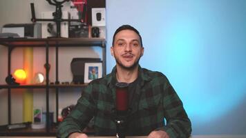 Man Hosting Podcast in Stylish Studio Setup Talking to Camera with Professional Microphone video