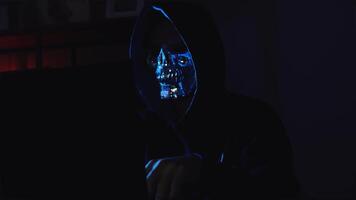 Dark web hacker using laptop in moody room showing online fraud, digital piracy, and system breach video
