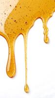 Golden honey dripping down, showcasing its viscous texture and purity photo
