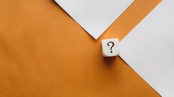 Conceptual Image Featuring a Question Mark Dice with Blank Papers photo