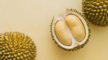 Studio shot of ripe durian fruit with its thorny outer shell against cream background photo