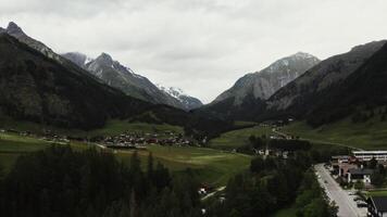 Panoramic shooting from a drone, a beautiful view of the village, located in a lowland between the Alpine mountains. Austria, mountain landscape aerial view photo