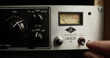 A man turns on a sound level meter, close-up of his hand, an unrecognizable person photo