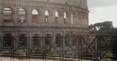 The Coliseum on a sunny warm day. Italy tourist attraction, Rome. Many tourists at the foot of the monument of architecture. in 4k, red komodo photo