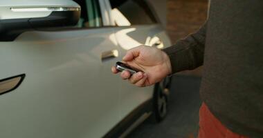 A man opens the car, close-up of his hands with a key, an unrecognizable person - unrecognizable photo