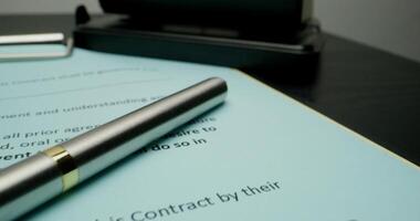 A signed contract, close-up of the signatures of the employer and the employee, the movement of the on the document photo