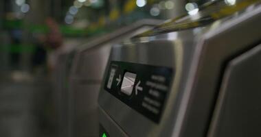 A woman inserts a card into a subway terminal and passes through. close-up of her hand, an unrecognizable person - terminal photo